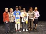 Craig student Oliver Price holds a trophy following his win at the state spelling bee Friday. Standing next to Price is Juneau student Brayden Wrightson, who took second place in the competition.